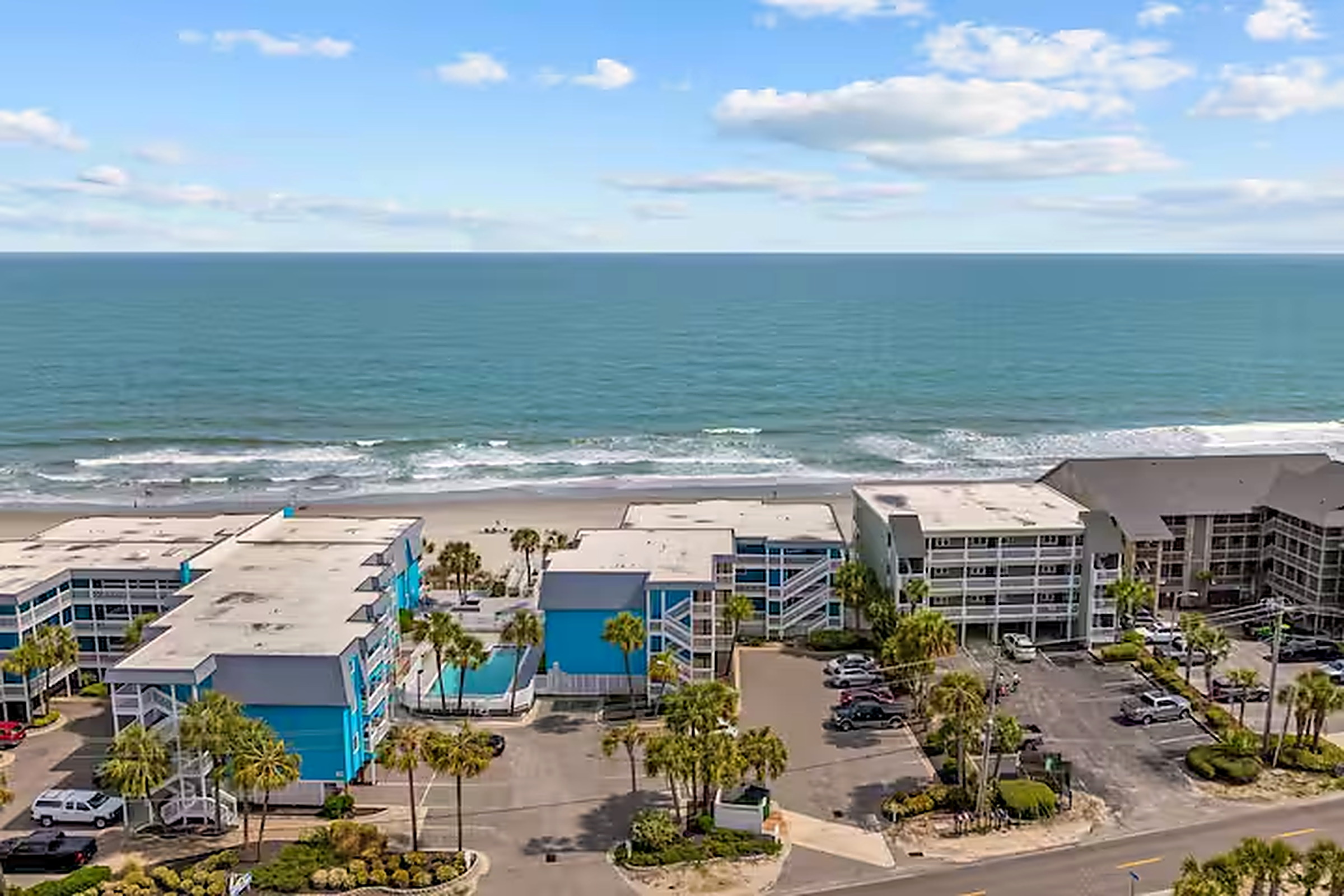 Aerial view of the oceanfront condo complex and pool directly on Garden City Beach, South Carolina